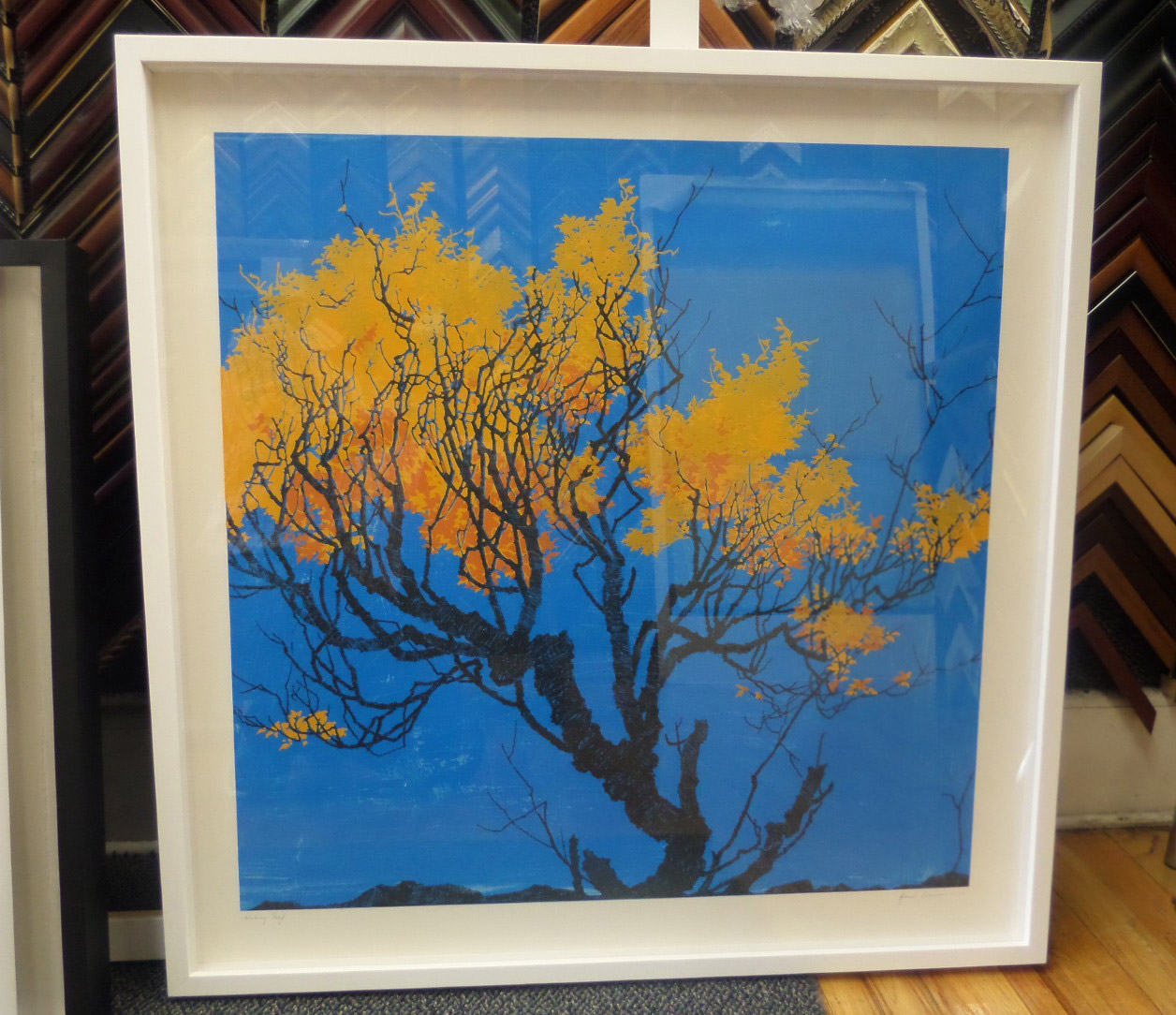 An orange tree on a blue background, a fine-art print in a white frame